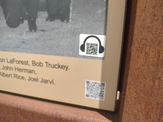 The ADA QR code on an interpretive sign in Firefighters Square