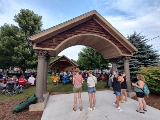 A gathering of people at the Breitung Park Band Shell