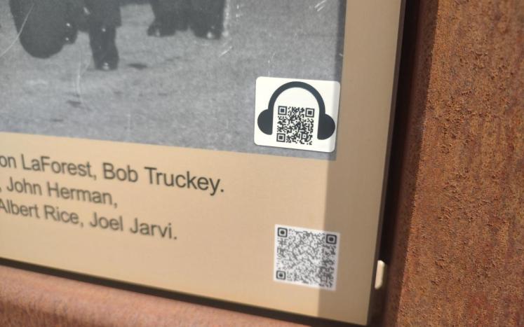 The ADA QR code on an interpretive sign in Firefighters Square